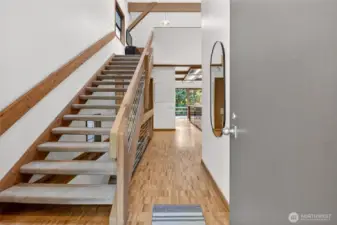 Entryway with floating stairs to the loft/multipurpose room (former architect's studio)