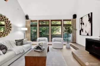 Main level living room with a wall of windows brings in plenty of light