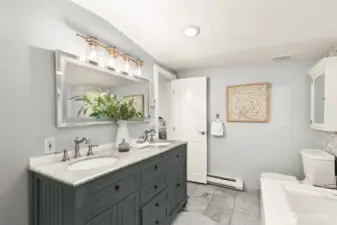 Updated primary bathroom with dual sinks, a jetted tub and a large shower for two!