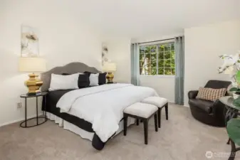 Primary Bedroom - window looks out to the trees by the back patio.