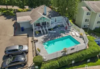 Here is a drone photo of the swimming pool, hot tub, and community clubhouse in the summer. Renton Ridge has great amenities!