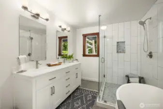 Double sink vanity, tiled shower.