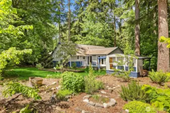 Landscaped gardens lead to the lawn, veggie beds and garden shed.