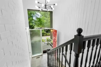 Heading downstairs, the entry/staircase is lit up by a new modern fixture.