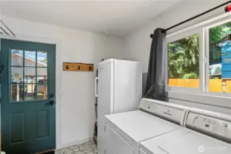 Laundry room with door to backyard.