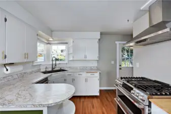 Charming efficient kitchen with backdoor access out to the garden area.