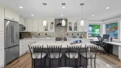 The kitchen showcases new cabinets with under-cabinet lighting, and stainless appliances.