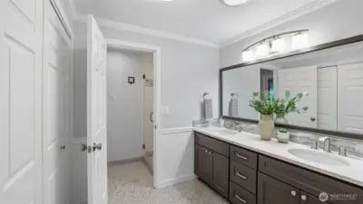 Primary ensuite features quartz dual vanity, two closets, separate full height tile shower, and solar tube lighting.