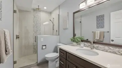 Updated 3/4 bathroom with walk-in shower, designer tile, quartz counter and new lighting