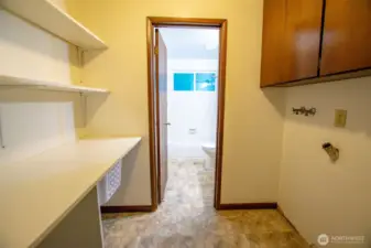 Space for Washer/Dryer and baskets leading to main bathroom