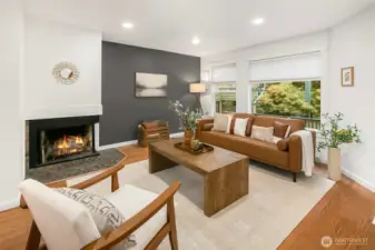 Bright living room with wood burning fireplace, double pane windows and oak hardwoods floors throughout.