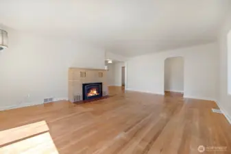 Gas fireplace insert in living room with sandstone surround... Beautiful curved archway details...