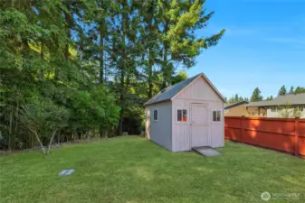 Handy shed and to the left going straight back is the added .59 acre wooded lot...