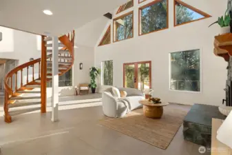 Dramatic great room showcases a soaring ceiling and wall of windows allowing the natural light to spill inside.