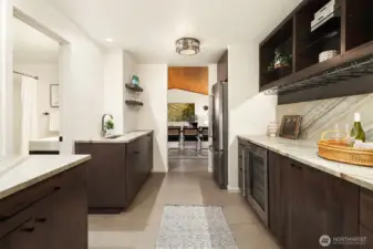 New bar remodel with quartzite slab counters, bar sink, and beverage/wine refrigerators.