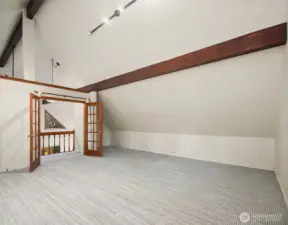 Another view of the upper level bonus room with access stairs to the back patio.