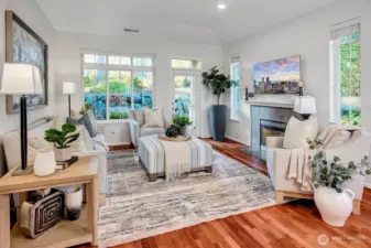 Super cozy family room with gas fireplace, painted millwork mantle, and a flat screen TV that will stay with the home. Blinds on all windows, and door flows out to the back patio that backs to a protected greenbelt.