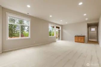 Walkout basement full of light with sink and sliding doors.