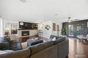 Spacious living room leads into dining space with French Doors to the deck
