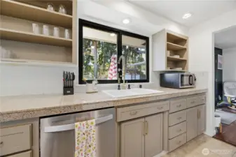 Kitchen looks out to backyard