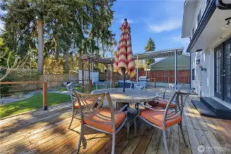 Large deck overlooking park-like yard with garden, greenhouse, chicken coup