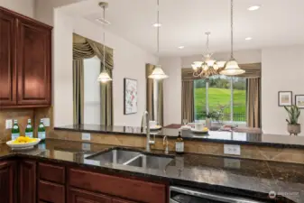 Kitchen is open to the dining room with raised bar.