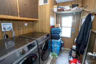 The utility room features additional cabinets, offering ample storage space.