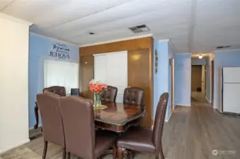 Dining area featuring a built-in cabinet cleverly hidden behind the sliding doors on the wall.