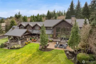 Escape without leaving home—welcome to your own private mountain lodge in the Uplands. This exceptional 7-acre estate, custom-built in Northwest timber style by Tom Banducci, offers unrivaled views of Mt. Si from nearly every room. A rare opportunity in the Uplands, this stunning home seamlessly blends natural beauty with modern convenience. Ideally located just 10 minutes from North Bend’s shops and dining, 20 minutes from Snoqualmie Pass, and only 25 minutes from Bellevue, it offers the perfect balance of seclusion and accessibility.