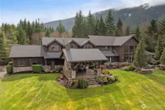 Escape without leaving home—welcome to your own private mountain lodge in the Uplands. This exceptional 7-acre estate, custom-built in Northwest timber style by Tom Banducci, offers unrivaled views of Mt. Si from nearly every room. A rare opportunity in the Uplands, this stunning home seamlessly blends natural beauty with modern convenience. Ideally located just 10 minutes from North Bend’s shops and dining, 20 minutes from Snoqualmie Pass, and only 25 minutes from Bellevue, it offers the perfect balance of seclusion and accessibility.