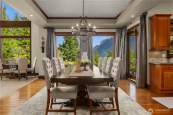 The elegant box ceiling frames the dining area as the windows frame the mountains.