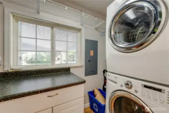Good sized laundry room with folding table & storage.