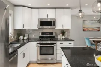 Island kitchen with new subway tile an stainless steel appliances (gas range!)