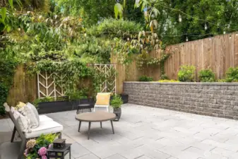 Beautiful 20'x20' patio with string lights and colorful plantings!