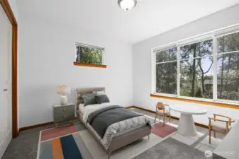 This bedroom looks out to the greenbelt at the front of the home.