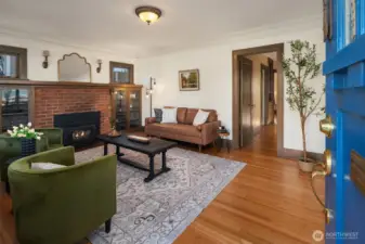 The living area invites you in with the gentle warmth of a crackling fireplace.