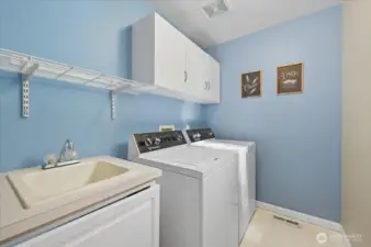 Utility room with sink and laundry