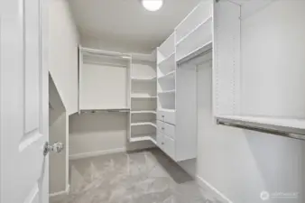 Oversized primary walk-in closet with plenty of extra storage