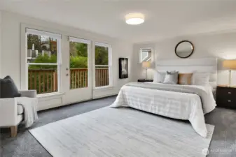 The primary suite is a true retreat, featuring a luxurious en-suite bathroom, walk-in closet, and a private balcony with glimpses of Lake Washington and the Cascade Mountains