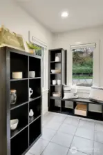 Located between the Kitchen and attached garage is a spacious utility/mud room with laundry, pantry and entrance to the ADU