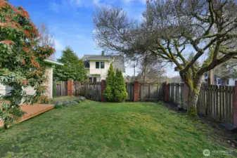 Step outside to your private backyard oasis, framed by mature trees & lush landscaping