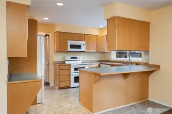 Kitchen view with double oven and eating bar