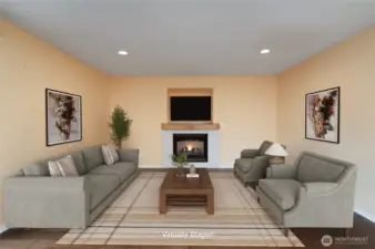 Virtually staged family room with gas fireplace and engineered hardwood floors