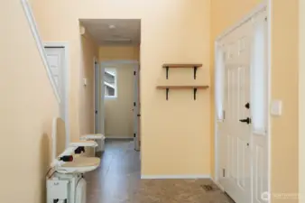 Front entrance showing the hallway to the half bath, laundry and garage. Stairlift provides addtional assistance to the 2nd floor.
