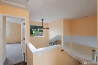 Upper floor landing open to the main floor below. Primary bedroom entrance is to the left of the photo.