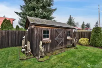 Enchanting whimsical storage building in the back yard