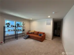 Spacious light filled living room open to the kitchen.
