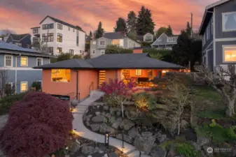 Ascend a gently sloping path to this lovely Midcentury home sited proudly in Queen Anne Park.