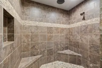 Tiled walk-in shower features 1 shower head + a rain shower!