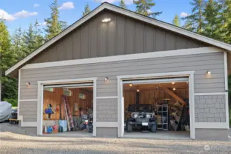 30x30 detached shop has a woodstove for heat, concrete floors & storage potential in the trusses above!